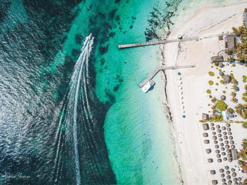 an aerial view of a beach with a boat in the water at Playa Norte Oceanfront Remote Work Plus Concierge in Isla Mujeres