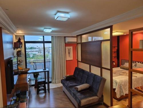 a living room with a couch and a bed at Flat no Hotel Millenium Manaus in Manaus