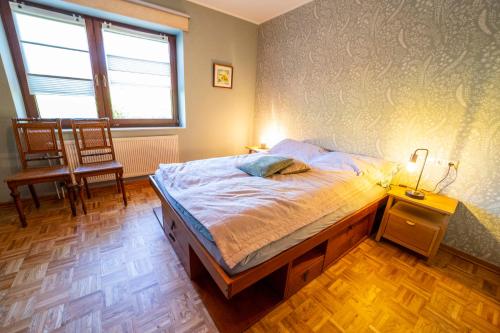 a bedroom with a bed and a chair and a window at Int Dörpe in Lengerich
