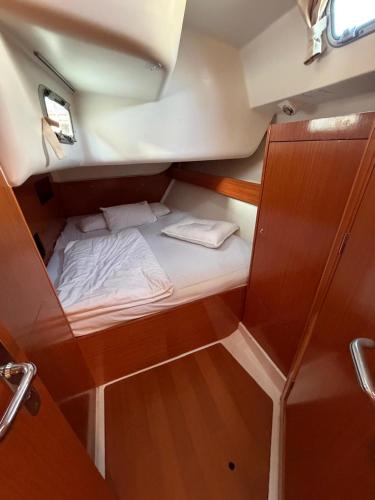 a small bed in the back of a boat at Dorfe Kotor Muo in Tivat