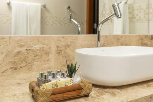 a bathroom sink sitting on top of a counter at Coral Plaza Apart Hotel in Natal