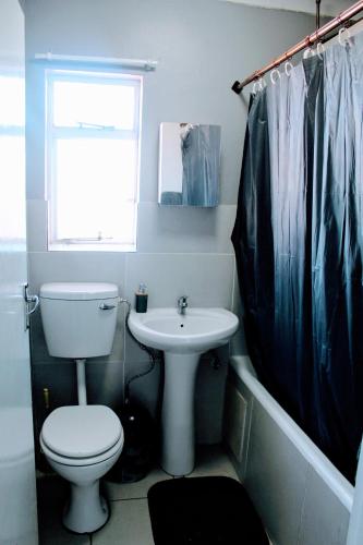 a bathroom with a toilet and a sink at Penthouse in Bloemfontein