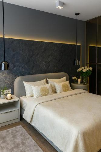 a bedroom with a large white bed with a black wall at Beograd na vodi-Belgrade Waterfront in Belgrade