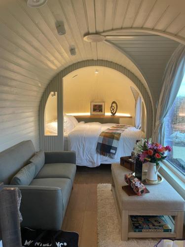 a bedroom with a bed and a couch in a room at The Hare's Lair in Monaghan