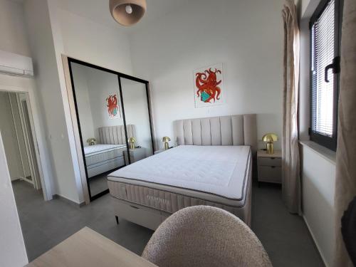 a bedroom with a bed and a mirror and a chair at Sea Star in Žman