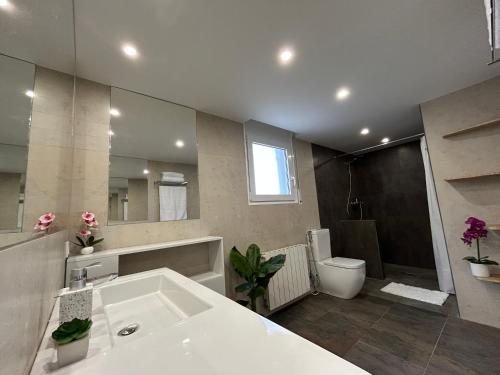 a large bathroom with a tub and a toilet at Villa La Gavina Sea View Pool and Beaches in Blanes