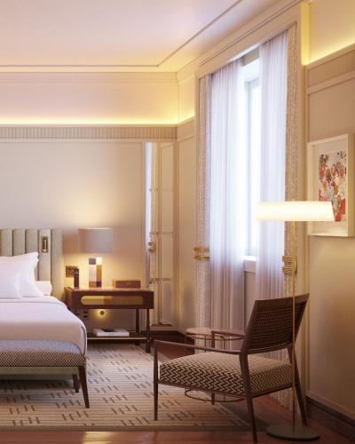 a bedroom with a bed and a chair and a desk at Copacabana Palace, A Belmond Hotel, Rio de Janeiro in Rio de Janeiro
