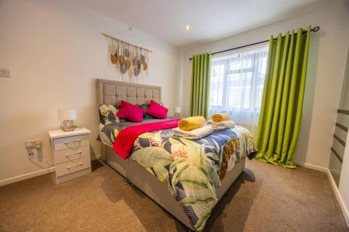 a bedroom with a bed with a teddy bear on it at Unique By Monique Kingsholm Bungalow Parking in Gloucester