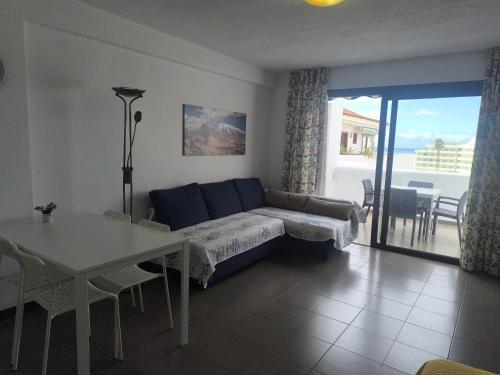 a living room with a couch and a table at Apartment Parque Royal Costa Adeje in Adeje