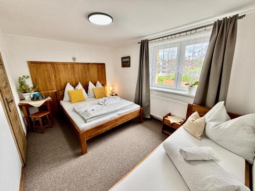 a bedroom with two beds and a window at Villa Slnecnica in Nová Lesná
