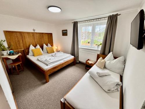 a hotel room with two beds and a window at Villa Slnecnica in Nová Lesná