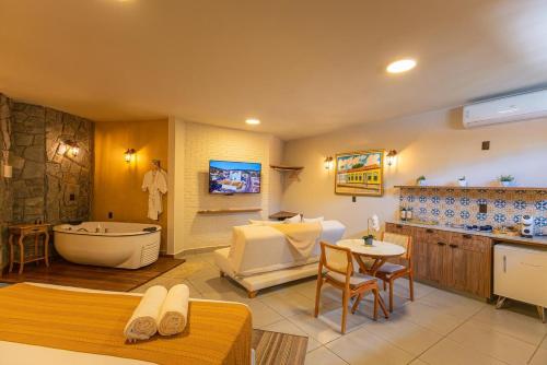 a bathroom with a tub and a sink and a bath room at Pousada Villa Mariana in Pirenópolis