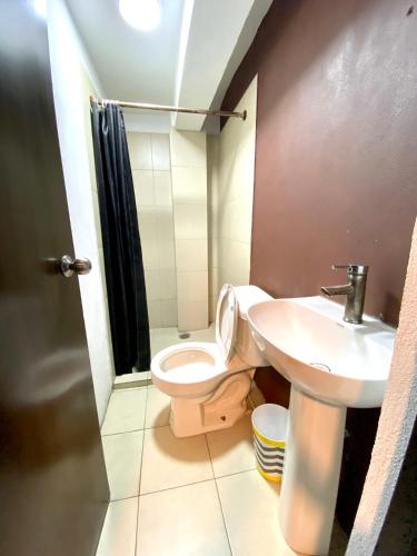 a bathroom with a toilet and a sink at R&A Hostal in Mexico City