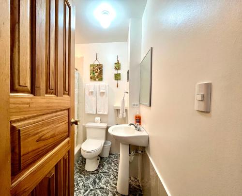 a bathroom with a white toilet and a sink at Vista Canyon Inn in Santa Ana