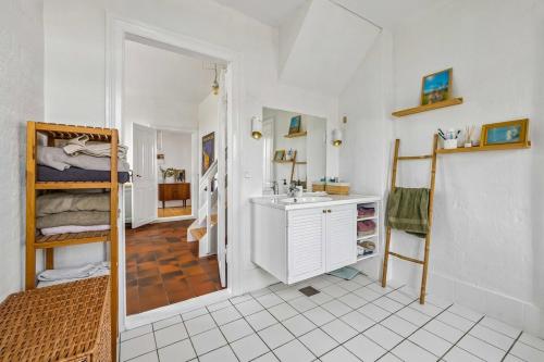 a bathroom with a sink and a bathroom with a bunk bed at Lakehouse in Vester Vandet