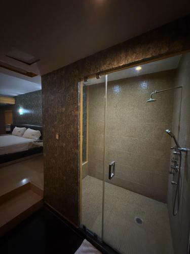 a shower with a glass door in a bathroom at DLUXE Auto Hotel ADULTS ONLY in Veracruz