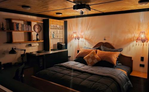 a bedroom with a bed with two lights on it at Algo Azul Something Blue in Wellington
