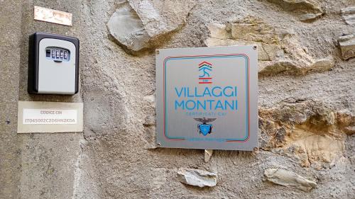 a sign on the side of a wall with a cell phone at La Romanina in Bagnone