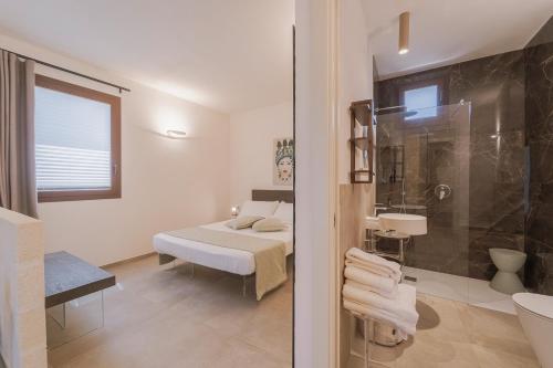 a white bathroom with a bed and a shower at Setteminne Resort Design in Favignana