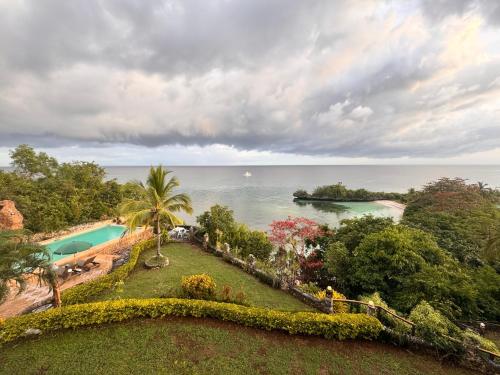 an aerial view of a resort with a swimming pool and the ocean at Camotes Harmony in Camotes Islands