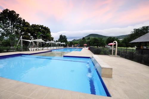 a large swimming pool with blue water at Villa Beatriz in Palestina