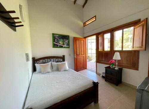 a bedroom with a bed in a room with windows at Villa Beatriz in Palestina