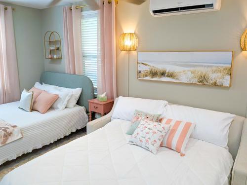 a bedroom with a bed and a couch with pillows at Heavenly Hideaway in Daytona Beach