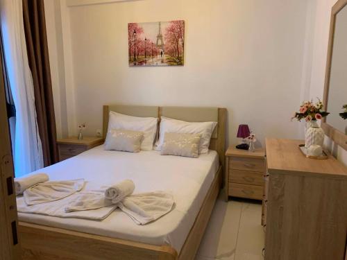 a bedroom with a bed with two towels on it at Miminllari APARTMENTS 2 in Pefkochori
