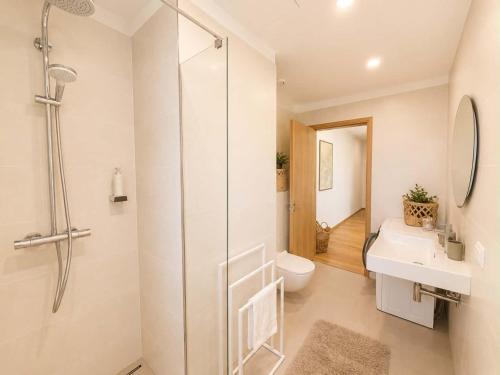 a bathroom with a shower and a toilet and a sink at Sadama Apartment in Haapsalu