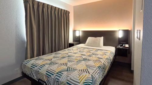 a hotel room with a bed and a window at Studio 6-Brownsville, TX in Brownsville