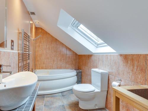 a bathroom with a white toilet and a sink at 3 Bed in Swansea oc-bn172 in Ystalyfera