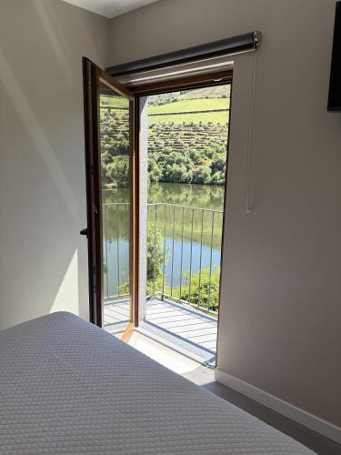 a bedroom with a large window with a view at Villa Tua in Castanheiro