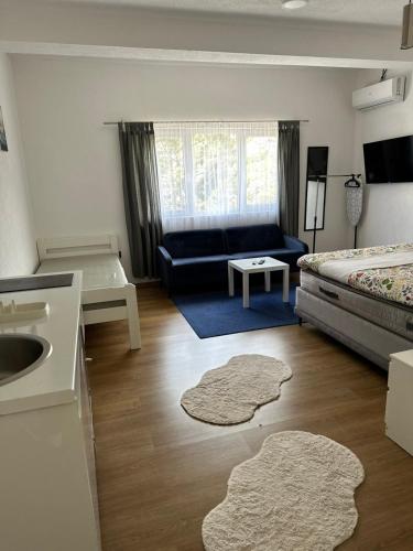 a living room with a bed and a couch at Apartmani Art in Jajce