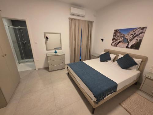 a bedroom with a bed and a television in it at Luxury Waterfront 3BR Apartment with Large Terrace in Marsaskala