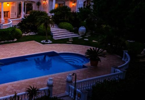 a swimming pool in the yard of a house at Tranquil Algarve Escape in Faro
