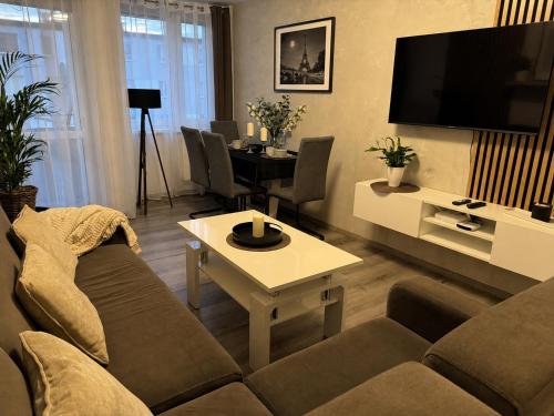 a living room with a couch and a table at Incanto Apartament os Kopernika in Starogard Gdański