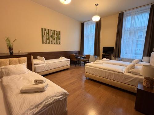 a hotel room with two beds and a living room at Livora Boutique in Budapest