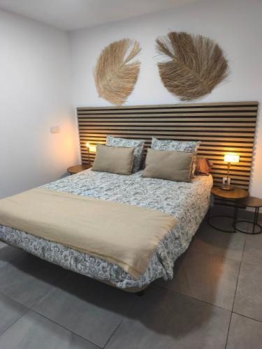 a bedroom with a large bed with two pillows at Central Apartment 4P Playa Chica Beach 2min WIFI in Puerto del Carmen