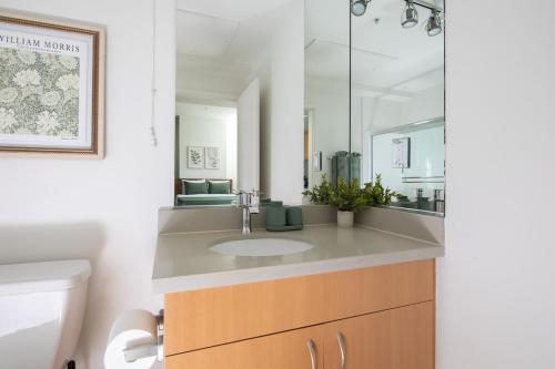 a bathroom with a sink and a mirror at Central Penthouse Studio with Free Parking in Los Angeles