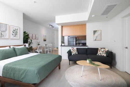 a bedroom with a bed and a living room at Central Penthouse Studio with Free Parking in Los Angeles