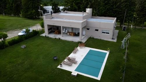 an aerial view of a house with a swimming pool at Casaquinta overlooking the golf course in Concepción del Uruguay