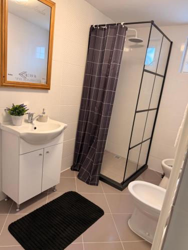 a bathroom with a sink toilet and a shower at CozyCloud in Poiana Mărului