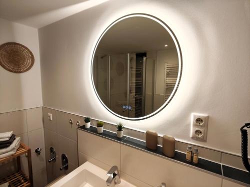 a bathroom with a sink and a mirror at Gasthaus Harmonie in Malchow