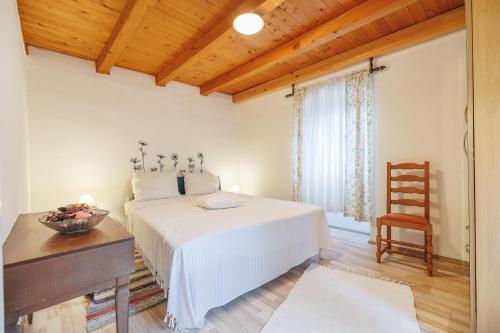 a bedroom with a bed and a desk and a chair at Castua Residence in Kastav