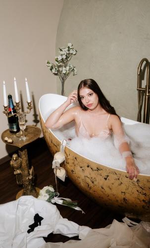 a woman is sitting in a bath tub at VICTORIAN HOUSE in Sibiu