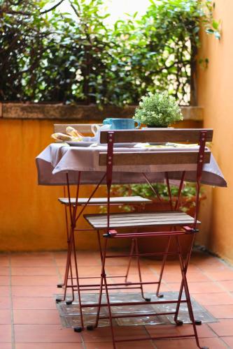 a table on a patio with a plant on it at Hotel Saini with Air conditioning in Stresa