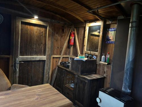 a room with a wooden cabin with a sink and a door at Sommerkino in Krispl
