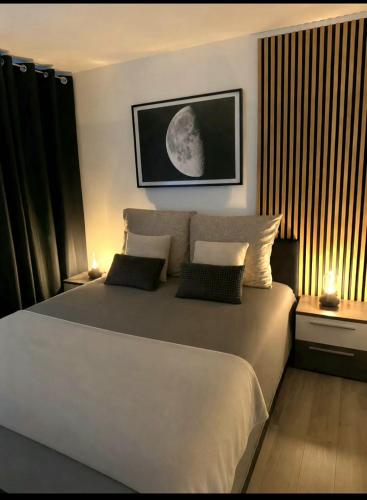 a bedroom with a large white bed with two lamps at Incanto Apartament os Kopernika in Starogard Gdański