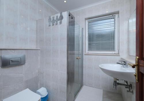 a bathroom with a shower and a sink and a toilet at Villa Kısmet in Fethiye