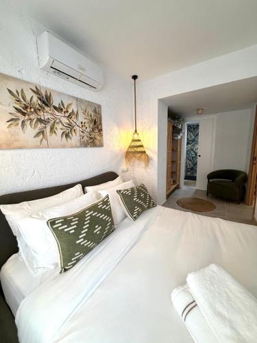 a bedroom with a white bed with pillows at Casa Natali 1 in Fuengirola